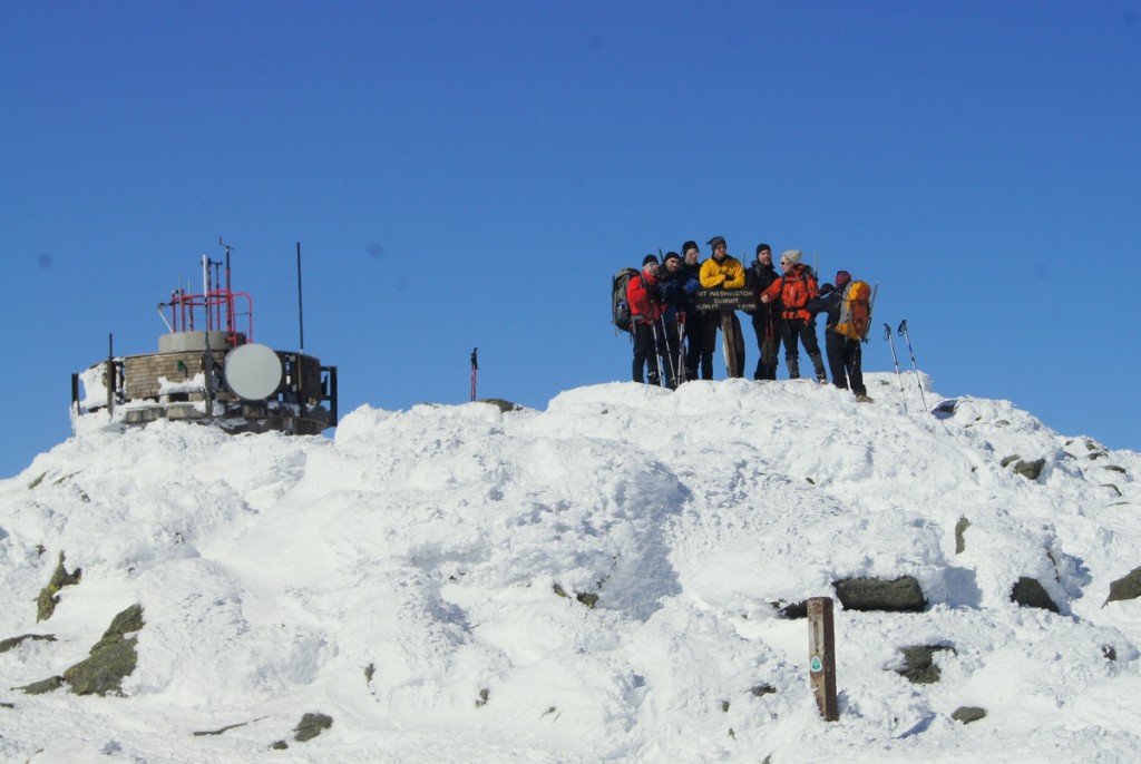 8 Group photo at summit sign