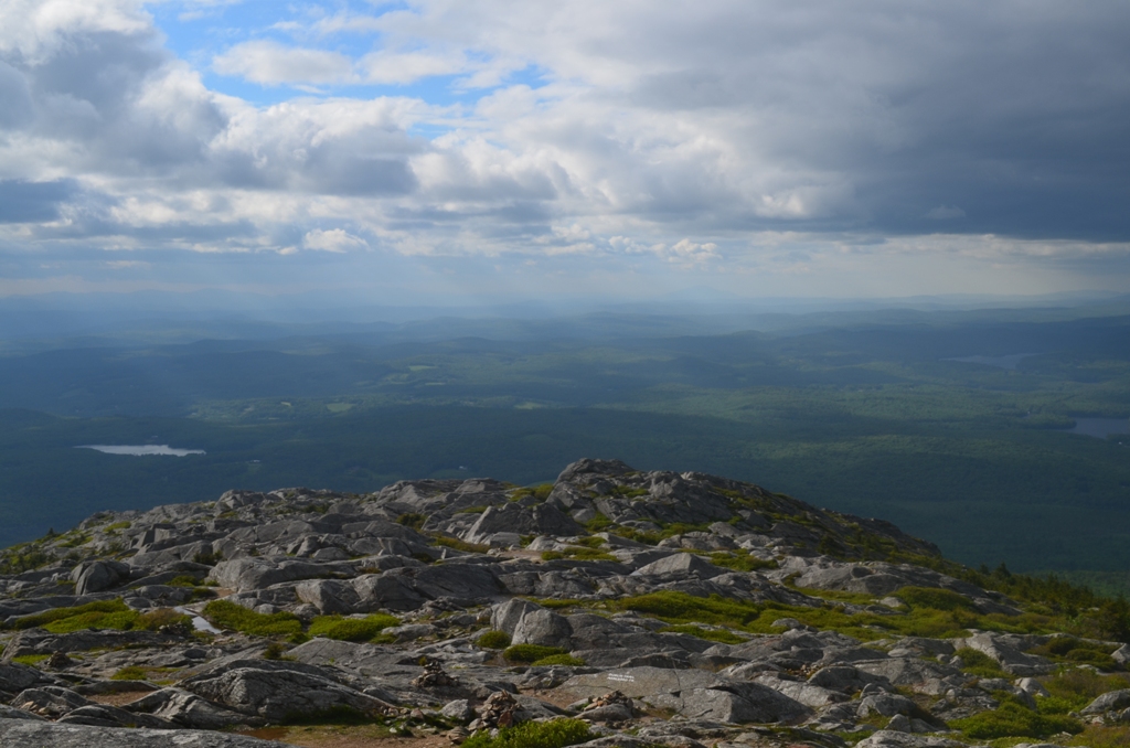 Light breaks through the clouds in the Monadnock Region, as seen from Monadnock's summit, providing welcomed rays of sun over the city of Keene. 06.12.13. Photo by Patrick Hummel.