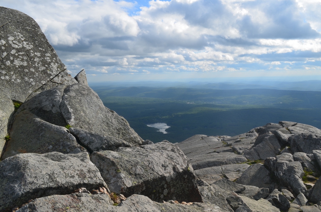 Local folklore, which may not be true, states that the gray wolves hid in the upper sections of Monadnock during the day and rove the valley hunting farm animals at night. This photo is peering to the south and Perkins Pond from Monadnock's summit. 06.12.13. Photo by Patrick Hummel.