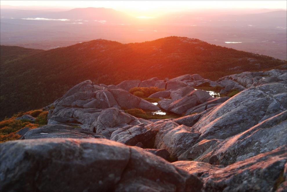 Viewed from the summit, the sun rises over the North Ridge of Mount Monadnock. Photo by Patrick Hummel.