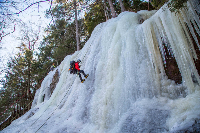rappelling down a wall of ice