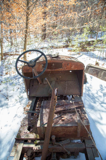 Old automobile artifact next to the trail