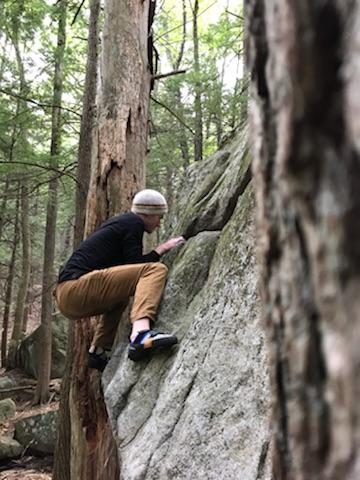 Interpretive Ranger climbing a huge boulder